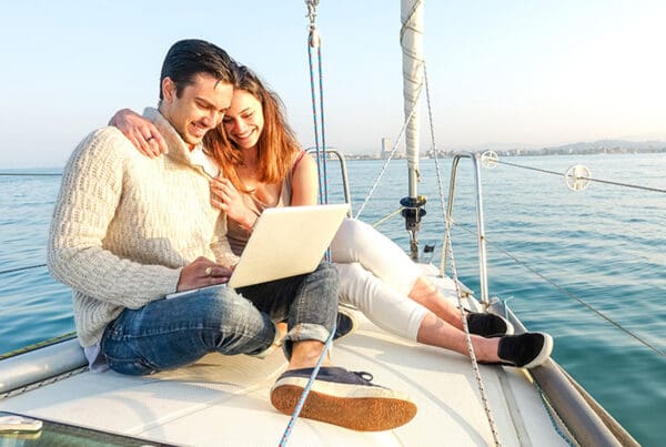 Blog - Couple Reading Laptop on Boat