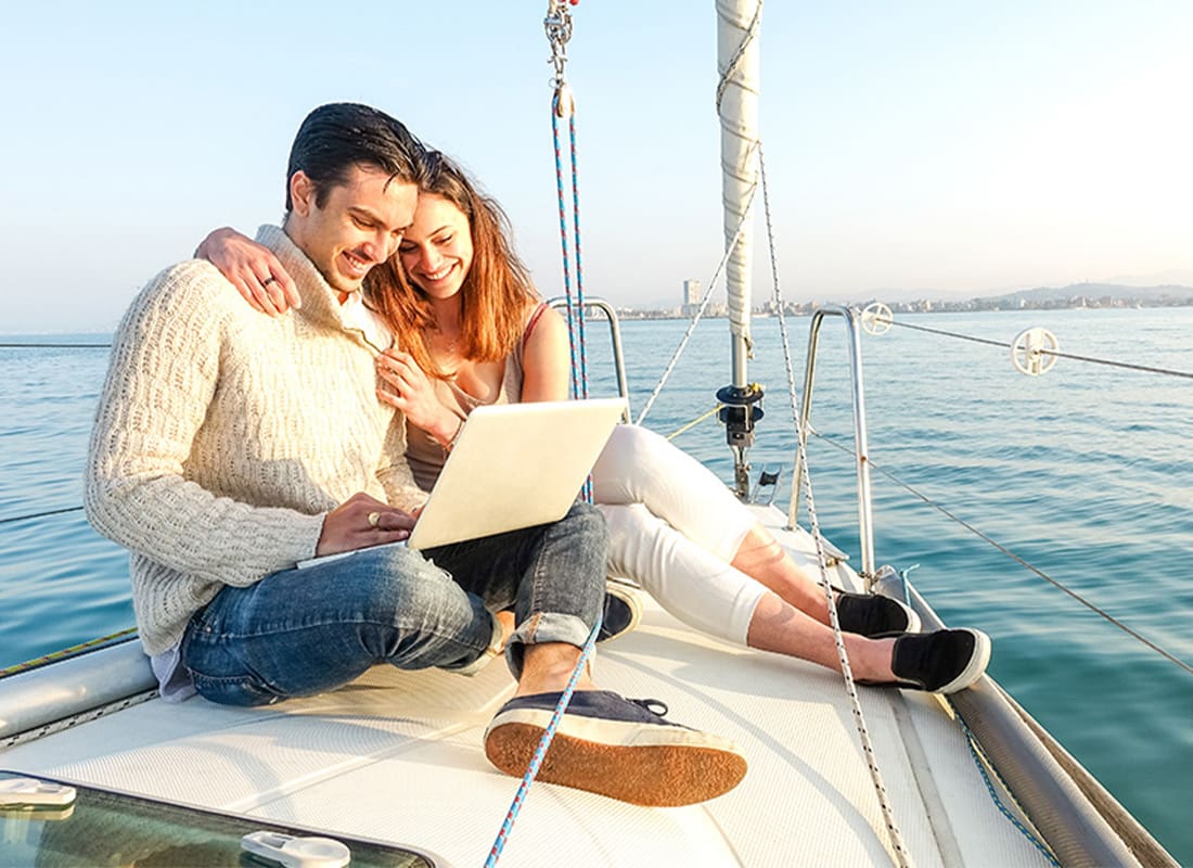 Blog - Couple Reading Laptop on Boat